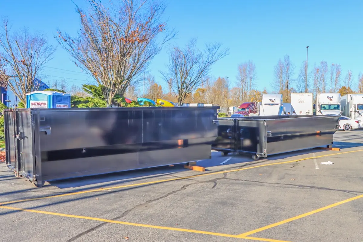Professional dumpster rental service with roll-off container on residential driveway in Massillon